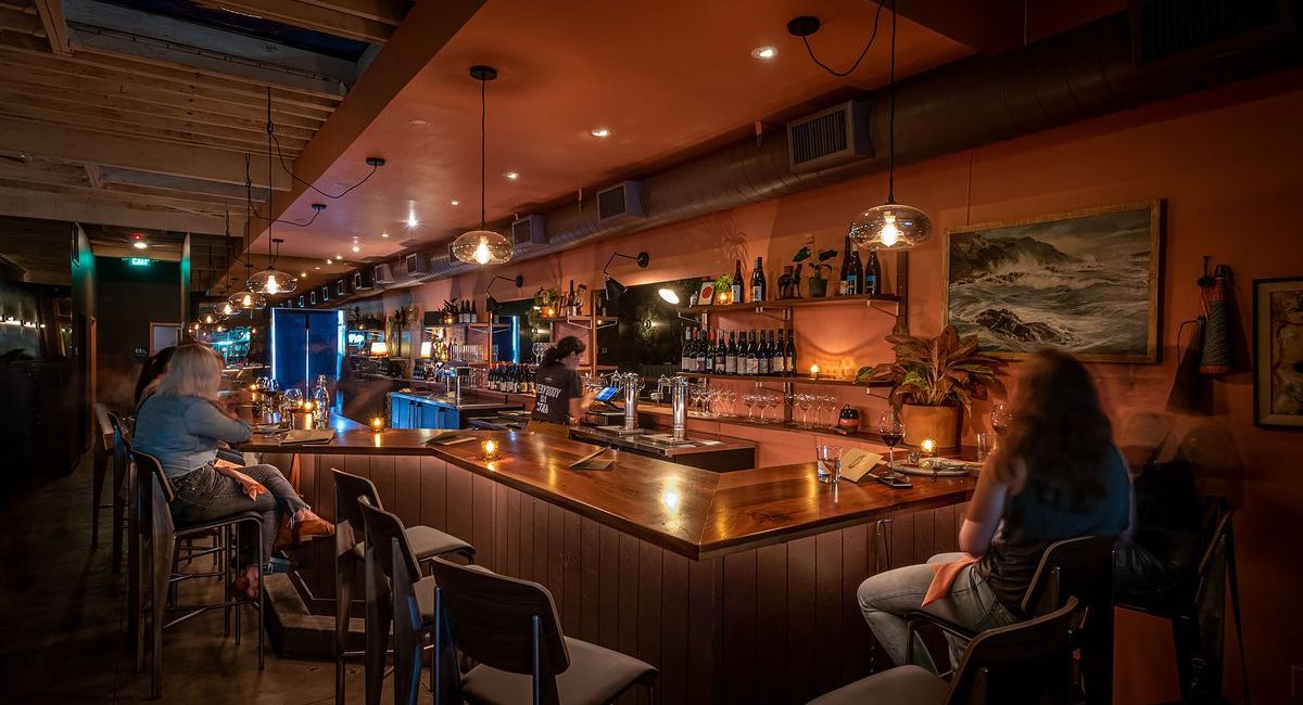 Bar Covell's interior with wine glasses and bottles on display