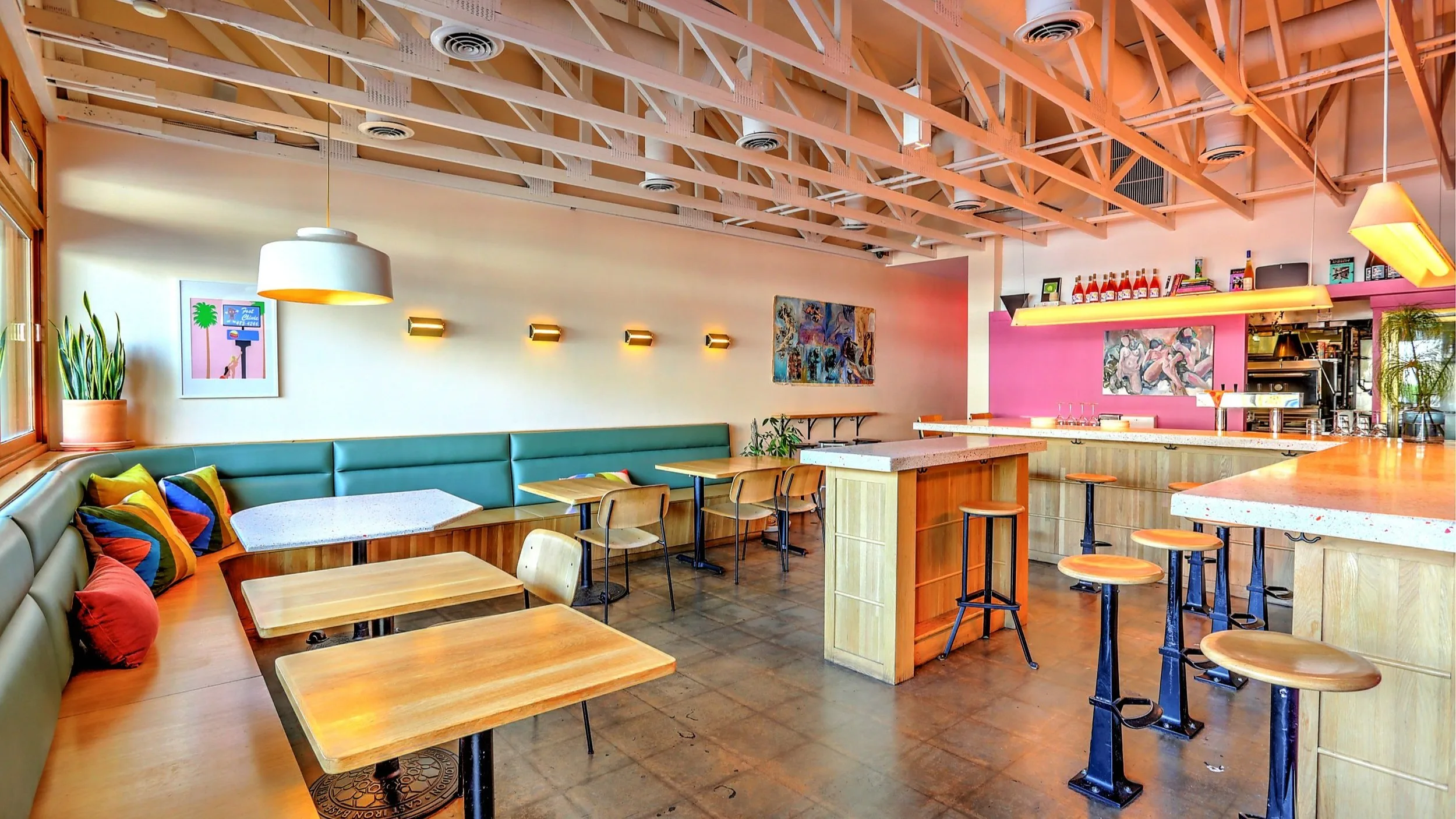 Cozy interior of a Los Angeles wine bar with bottles displayed on wooden shelves