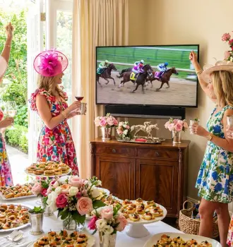 elegant Kentucky Derby party at home women spring floral dresses wine glasses mint juleps