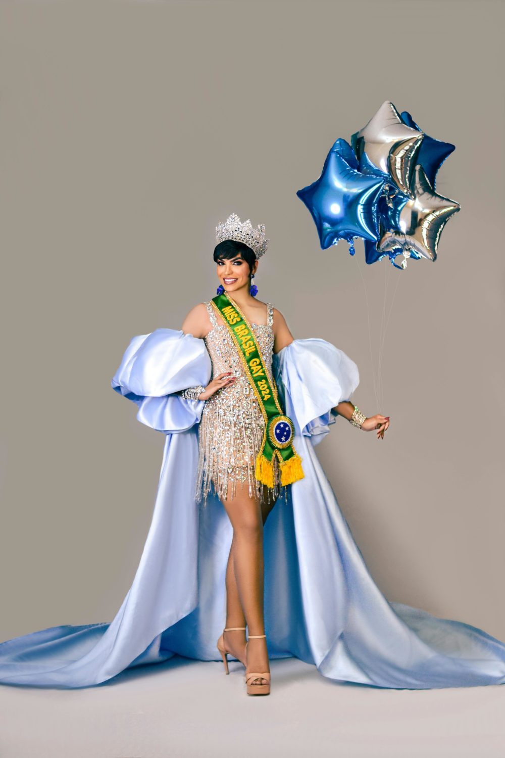 Beauty Pageant Queen in Pageant dress and crown with balloons 