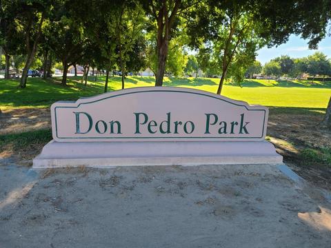 Looking east past the park sign along the north edge of the park. Walnut Avenue is at far left in this photograph.