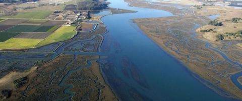 Aerial view of Elkhorn Slough, including Elkhorn Slough reserve (near left) and Moonglow Diary (distant left)