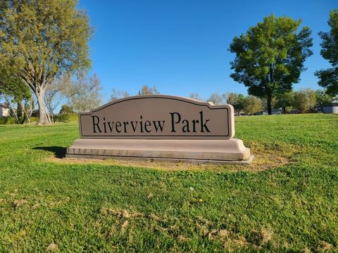 View of the park sign, looking north from the intersection of Riverpark Drive and River Valley Circle.
