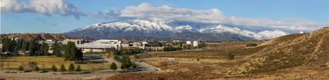 View of CSUSB (left) and Badger Hill (right) with the San Gabriel Mountains in the background.