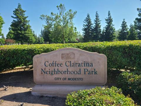 Coffee-Claratina Neighborhood Park sign at the corner of Grecian Avenue and Drakeshire Drive.