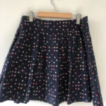 Featured thumbnail for Short pleated skirt with polka dots