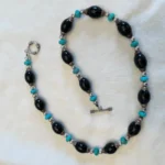 Featured thumbnail for Collier avec onyx et turquoises