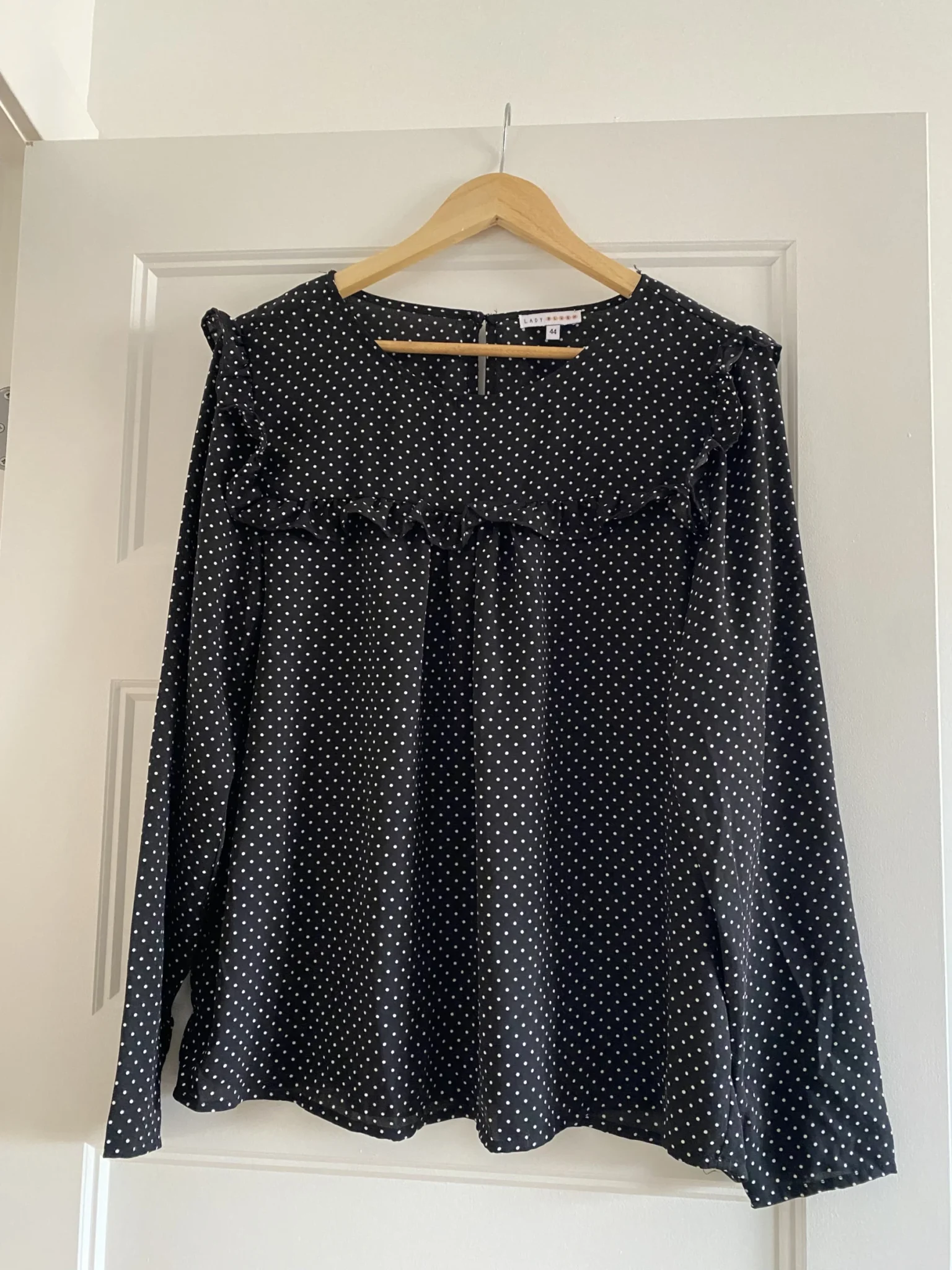 Featured image for Black blouse with white polka dots