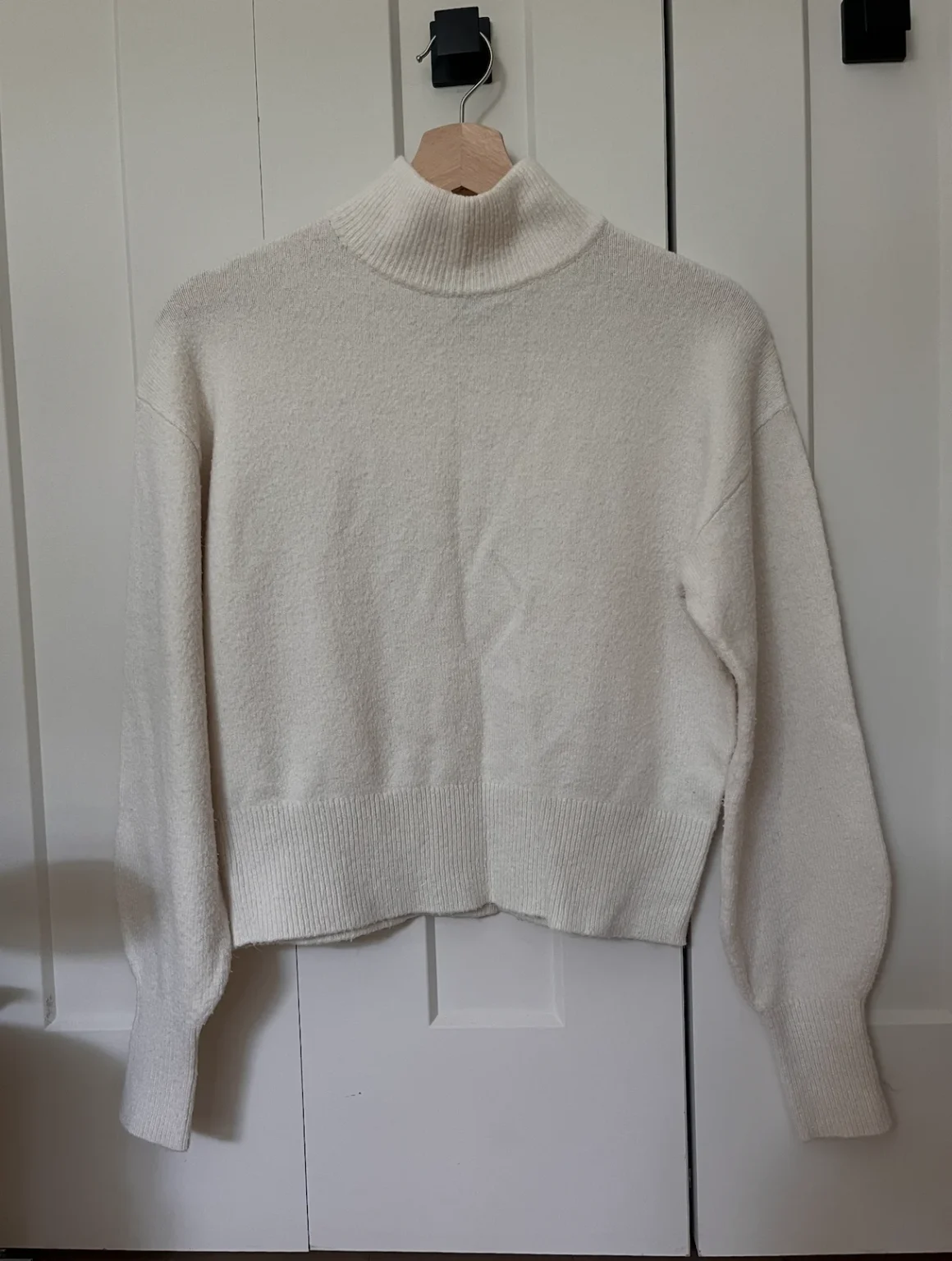Featured image for Wool jumper with a high collar