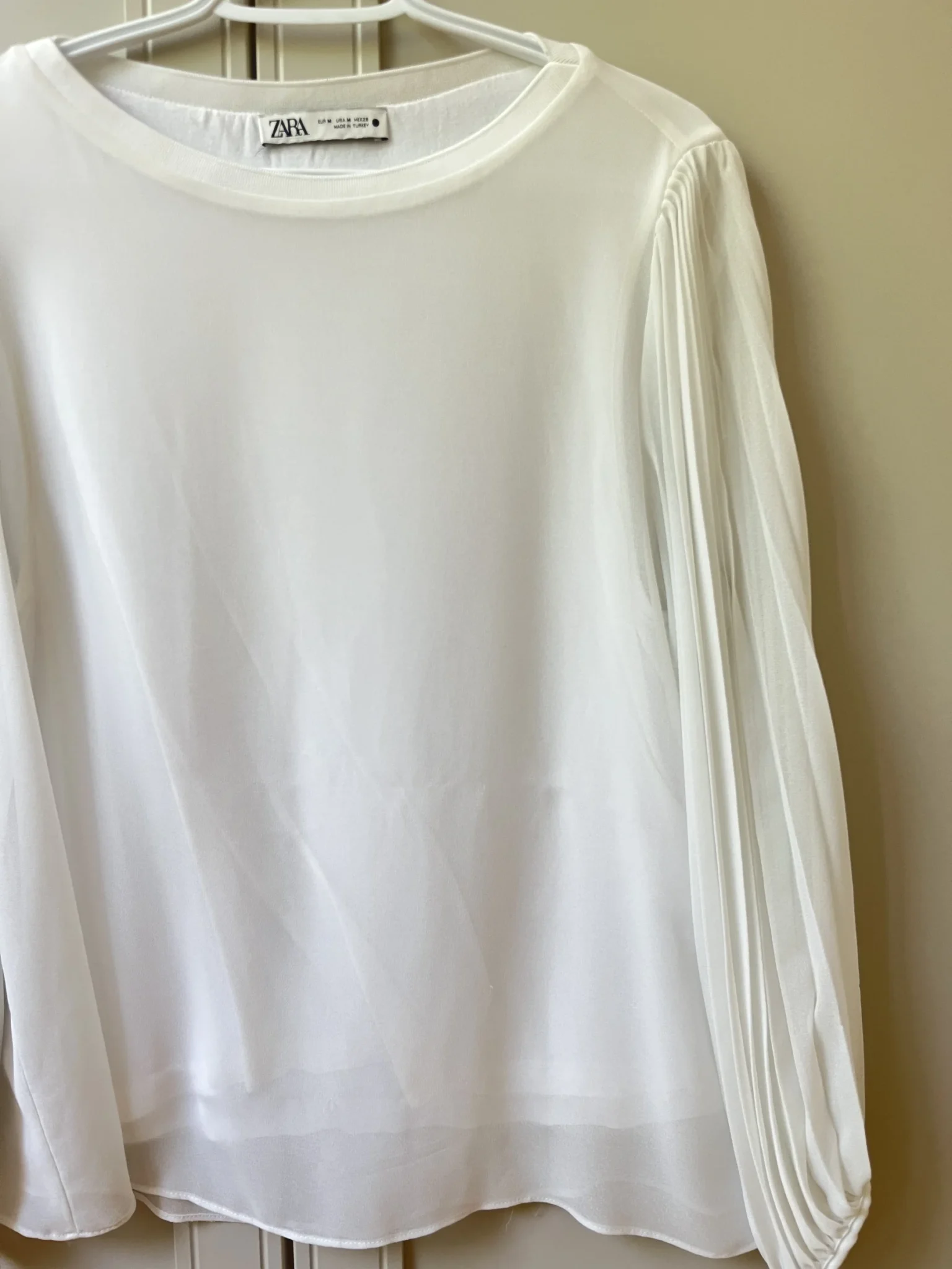 Image for White, loose-fitting top with sheer balloon sleeves