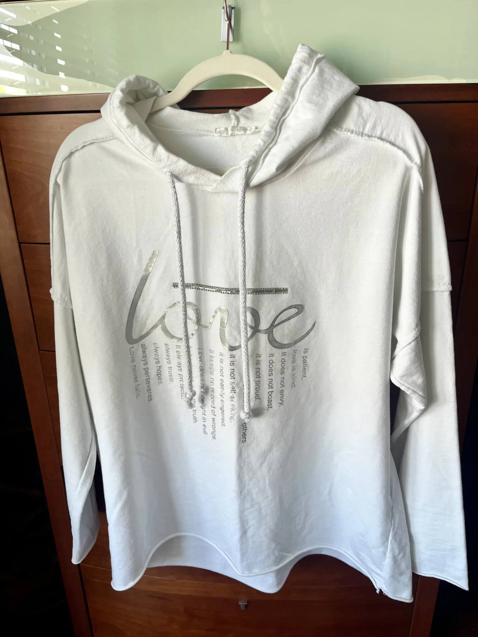 Featured image for A lovely white hoodie in a large size with an original slogan on the front.