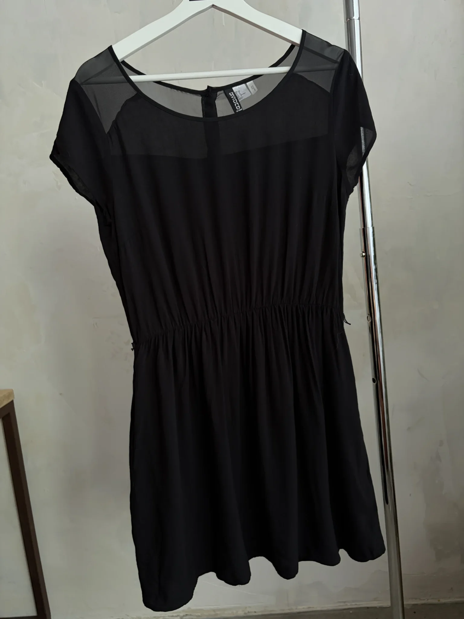 Featured image for Short little black dress with sheer shoulders