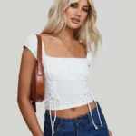 Featured thumbnail for T-Shirt Blanc Froncé à Lacets Princess Polly White Ruched Crop Top T-Shirt with Lace Up Detail