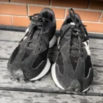 Thumbnail for Black New Balance trainers with an animal print