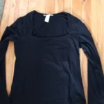 Featured thumbnail for Black long-sleeved top with a low-cut square neckline – size M