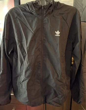 Black hooded windbreaker from Adidas Originals featuring the classic trefoil logo on the chest Adidas seconde main