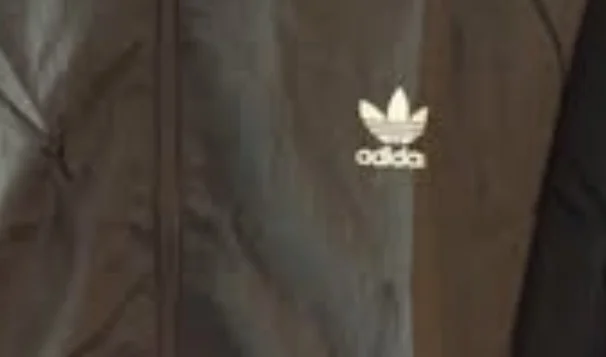 Image for Black hooded windbreaker from Adidas Originals featuring the classic trefoil logo on the chest