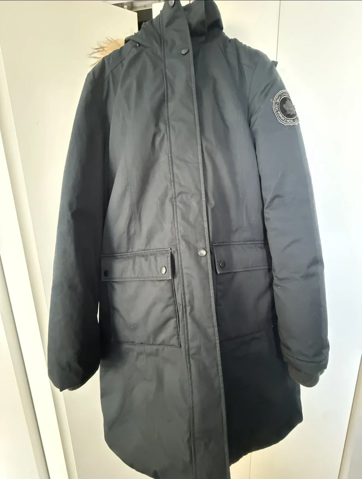 Image for navy blue coat with a fur-trimmed hood