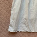 Thumbnail for THINGS BETWEEN – A flirty white babydoll dress with openwork lace and scalloped trim – G