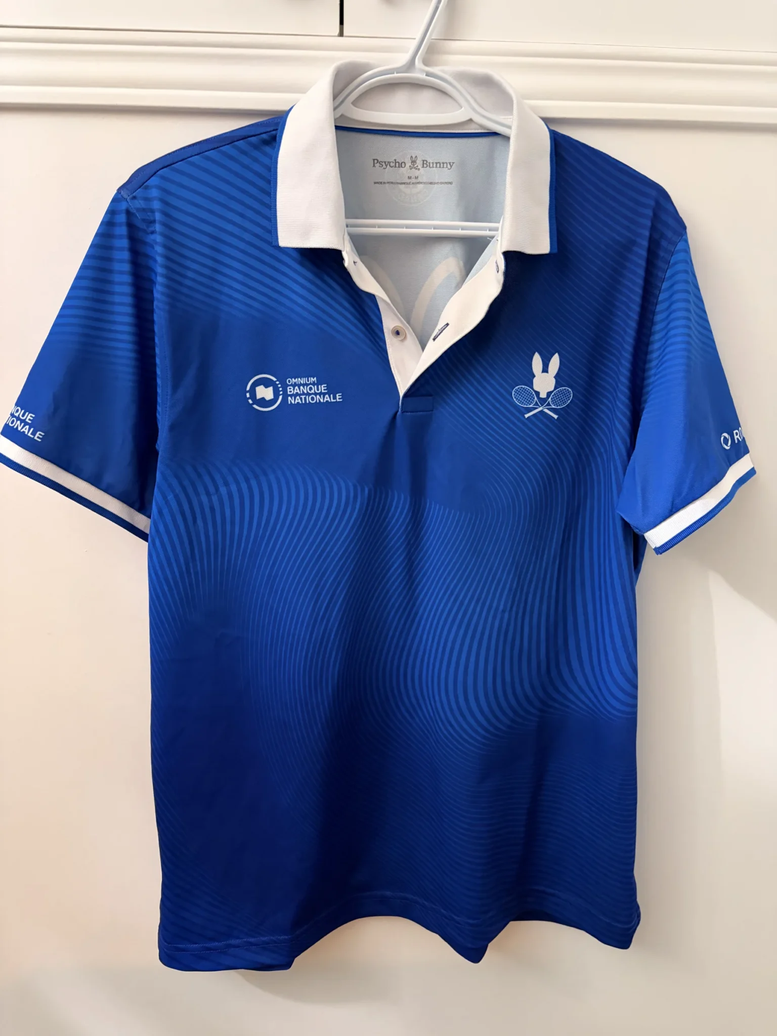 Featured image for Official Omnium Banque Nationale 2026 Psycho Bunny polo shirt