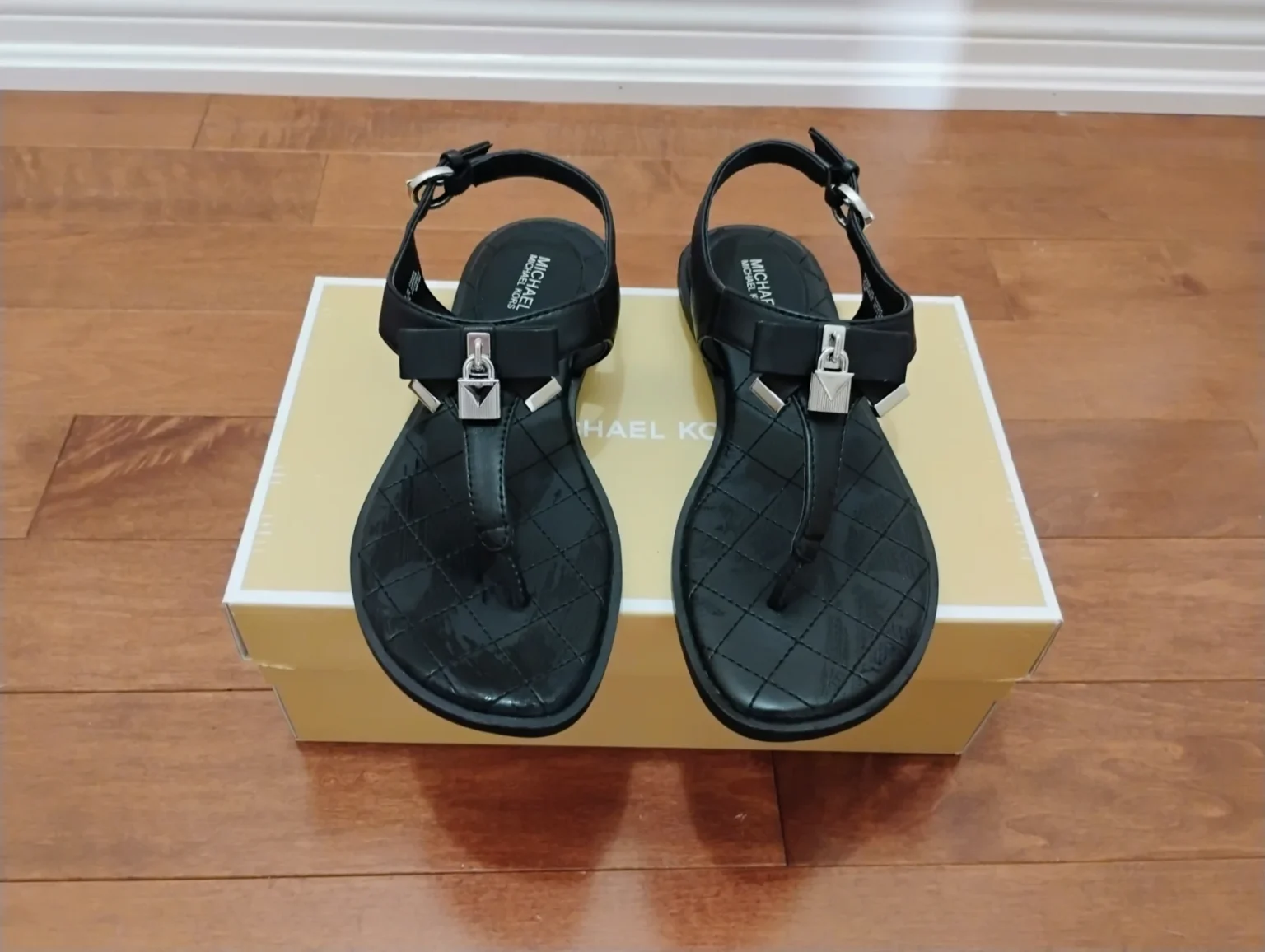 Featured image for Michael Kors Black Quilted T-Strap Sandals with Silver Hardware