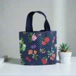 Featured thumbnail for Sac fourre-tout Oscar de La Renta en toile à motifs floraux et à pois