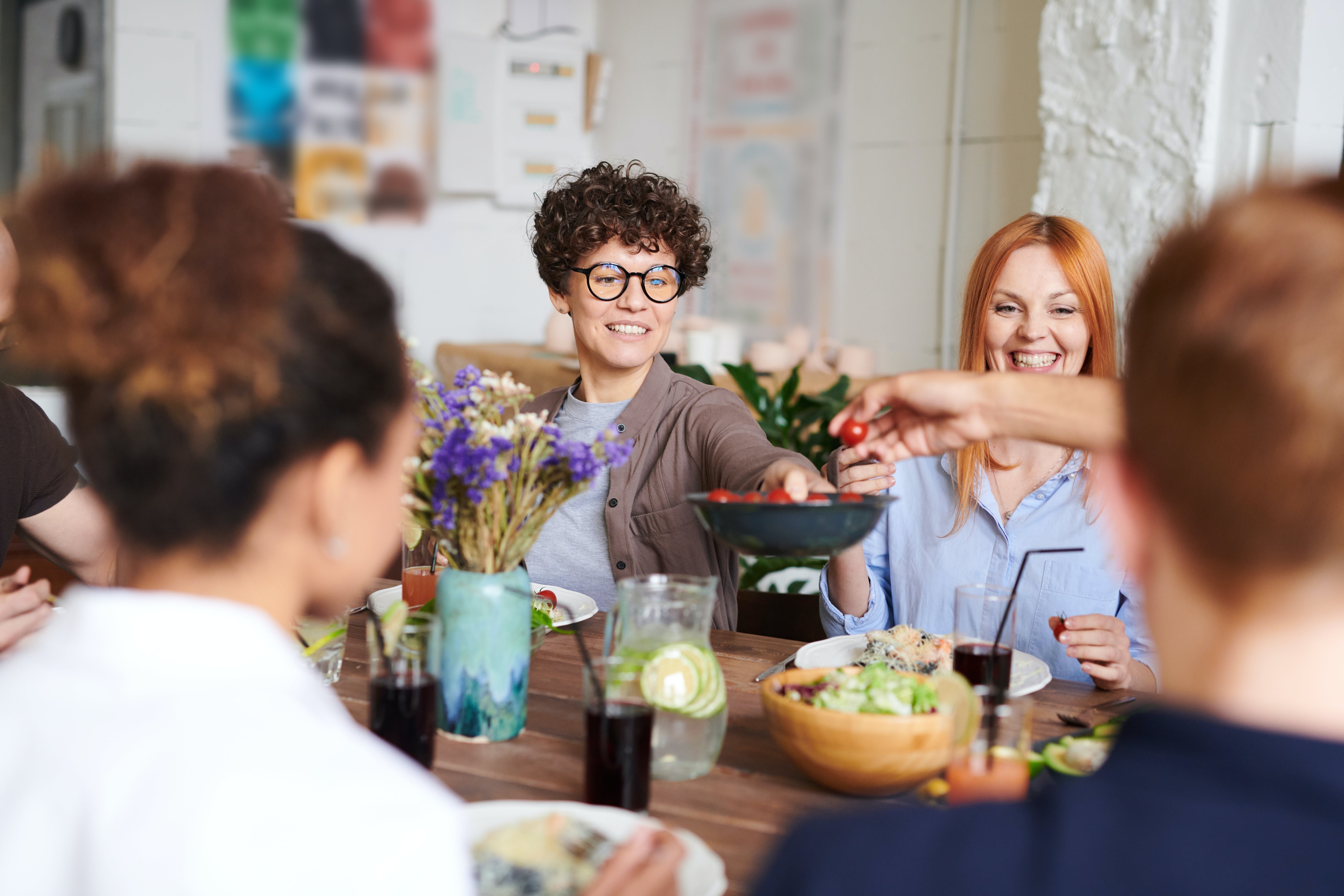 People sitting around a table enjoying a meal together