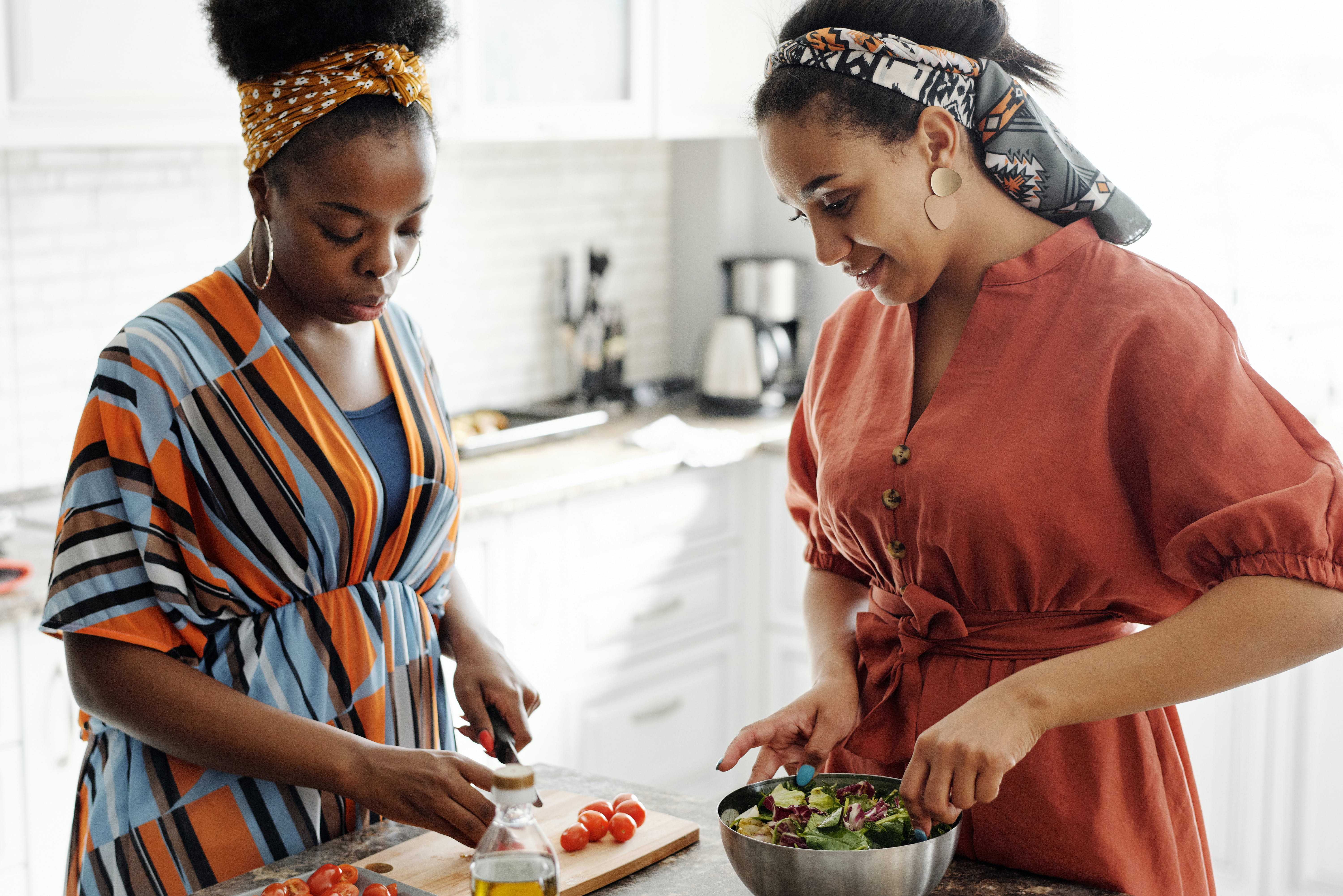 Two women preparing a salad