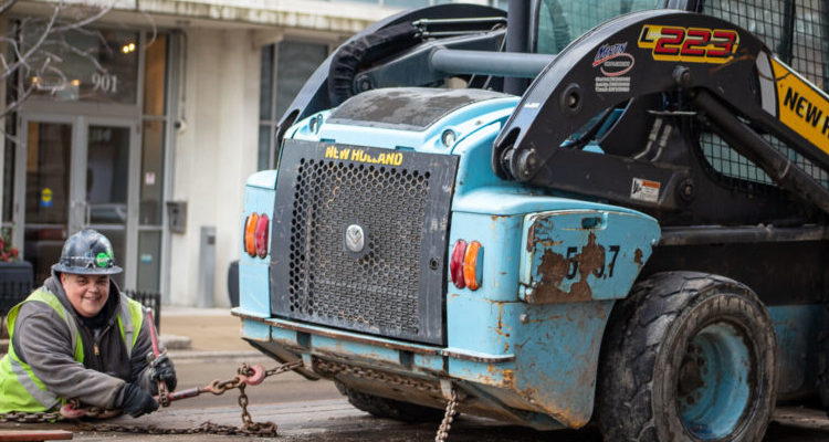 worker unloading skid steer chicago digital transformation