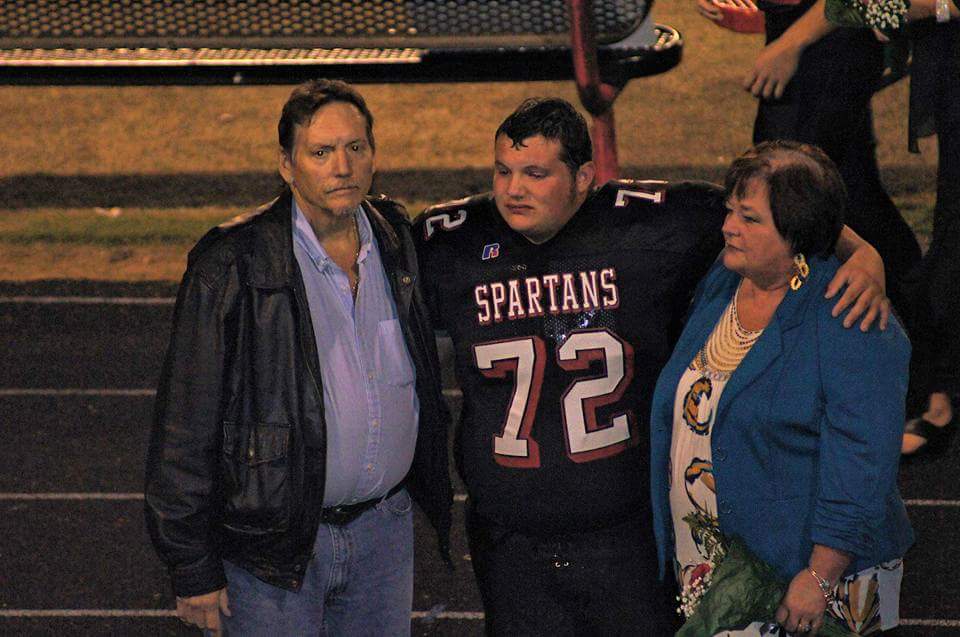 Phillip Walker with his late parents, Dana and Tammy Walker, during his senior season at Central Davidson High School. Walker football