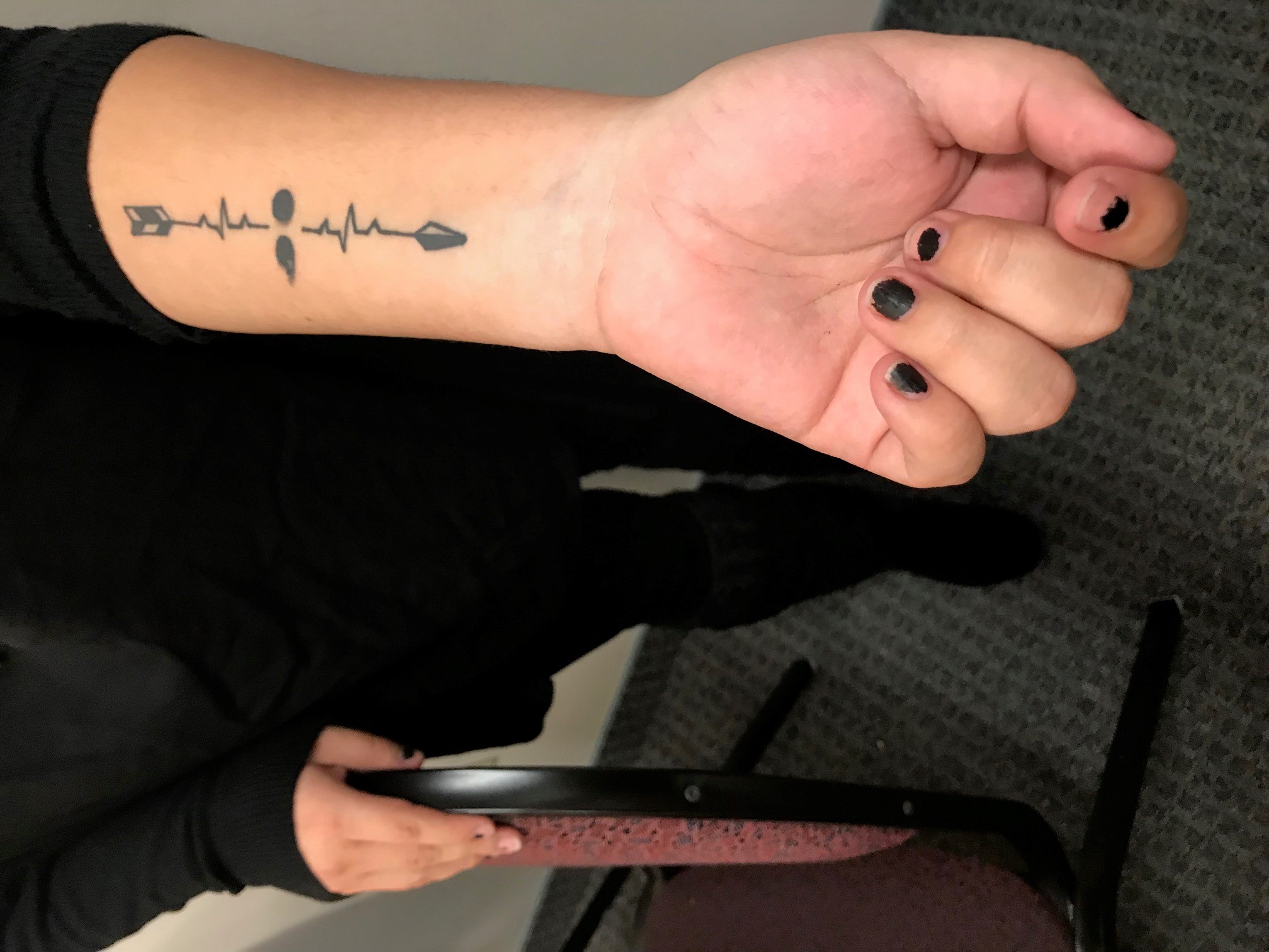 Sosa Cruz's tattoo from after her time in the hospital symbolizes life continuing after a suicide attempt. Poet2
