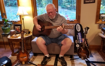 Tom Sharpe plays the guitar at his house in Winston-Salem Tom Sharpe plays the guitar at his house in Winston-Salem