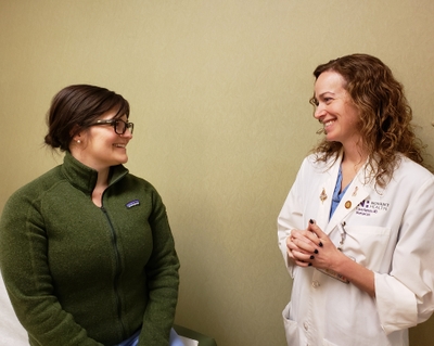 Dr. Laura Ramsay talks with a patient at Novant Health WomanCare. Dr. Laura Ramsay with patient at Novant Health WomanCare in Winston-Salem