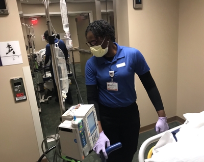 Manouchka Philippe helps transport a patient at Novant Health Presbyterian Medical Center. Manouchka Philippe a patient transporter at Novant Health Presbyterian Medical Center