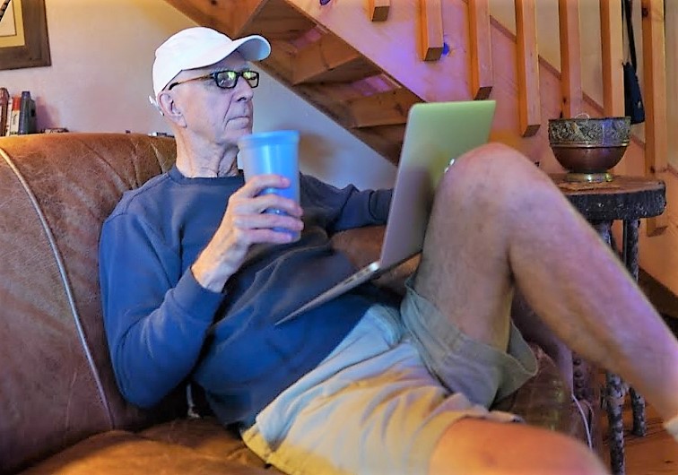 Larry Hicks regained use of his right hand after incisionless brain surgery. Larry on couch