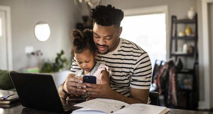dad and daughter look online laptop ipad virtual visit