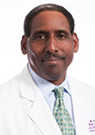 Dr. James Roberts is wearing a white lab coat and is smiling into the camera.
