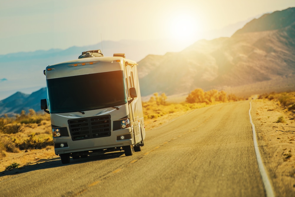 A Class A RV driving on the open road.