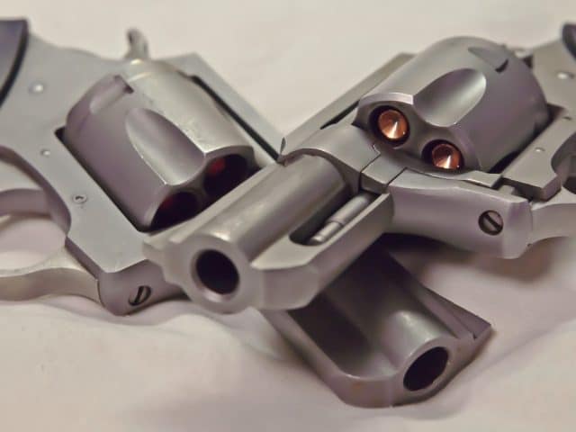 Two stainless revolvers, a 44spl and a 357 magnum on top of one another
