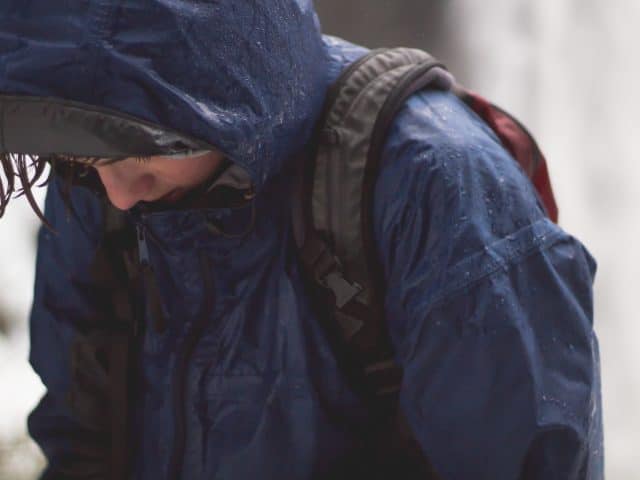 Hiker Wearing Raincoat Getting Wet in the Rain