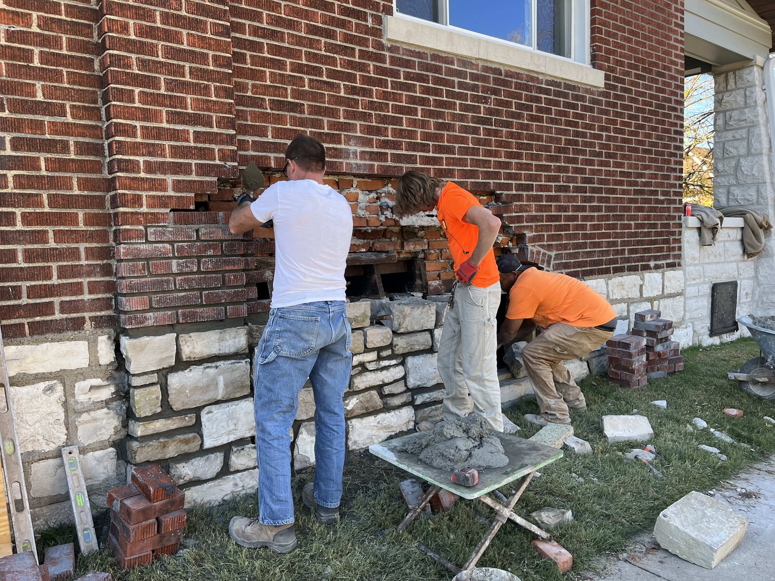 Bricklayers making repair.