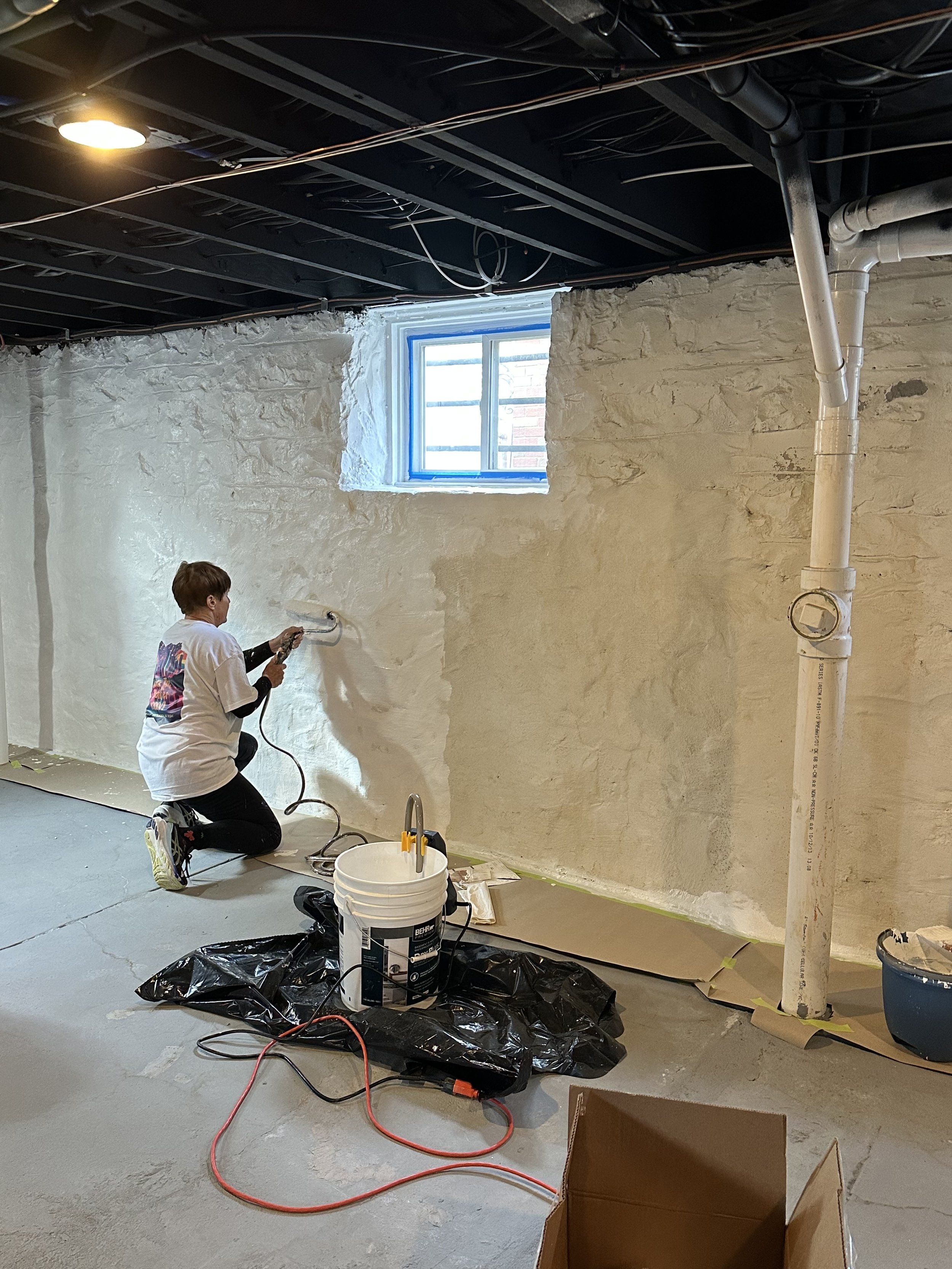 Painting basement wall.