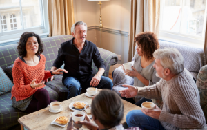 Group of friends socializing around a coffee table.