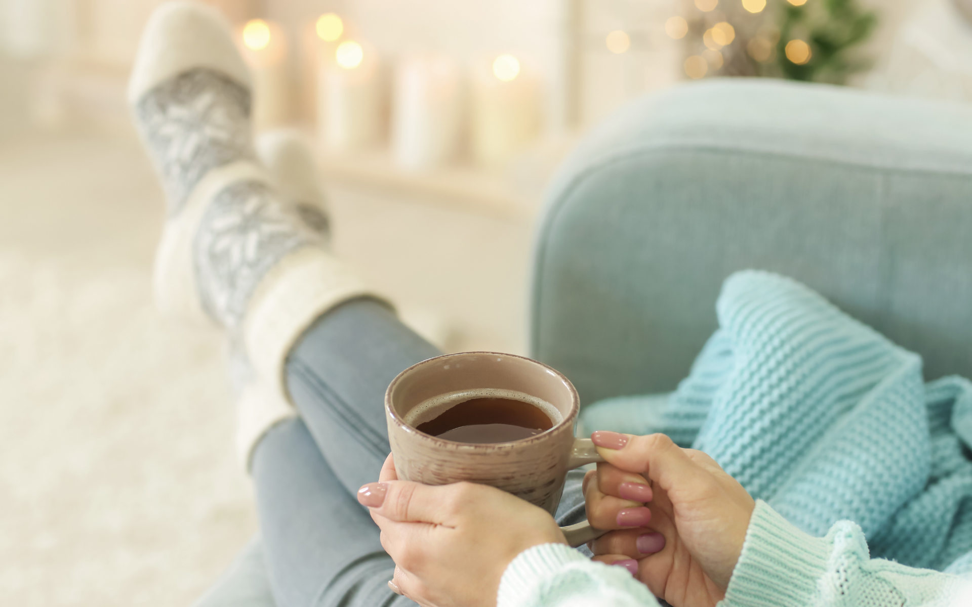 Woman relaxing at home with cup of coffee