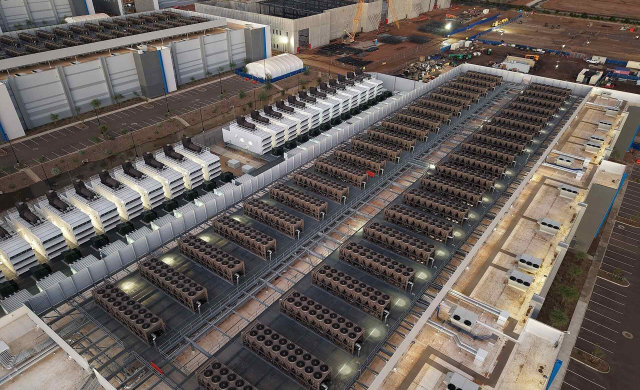 Aerial view of a large-scale industrial data center facility in the Midwest with external cooling units.