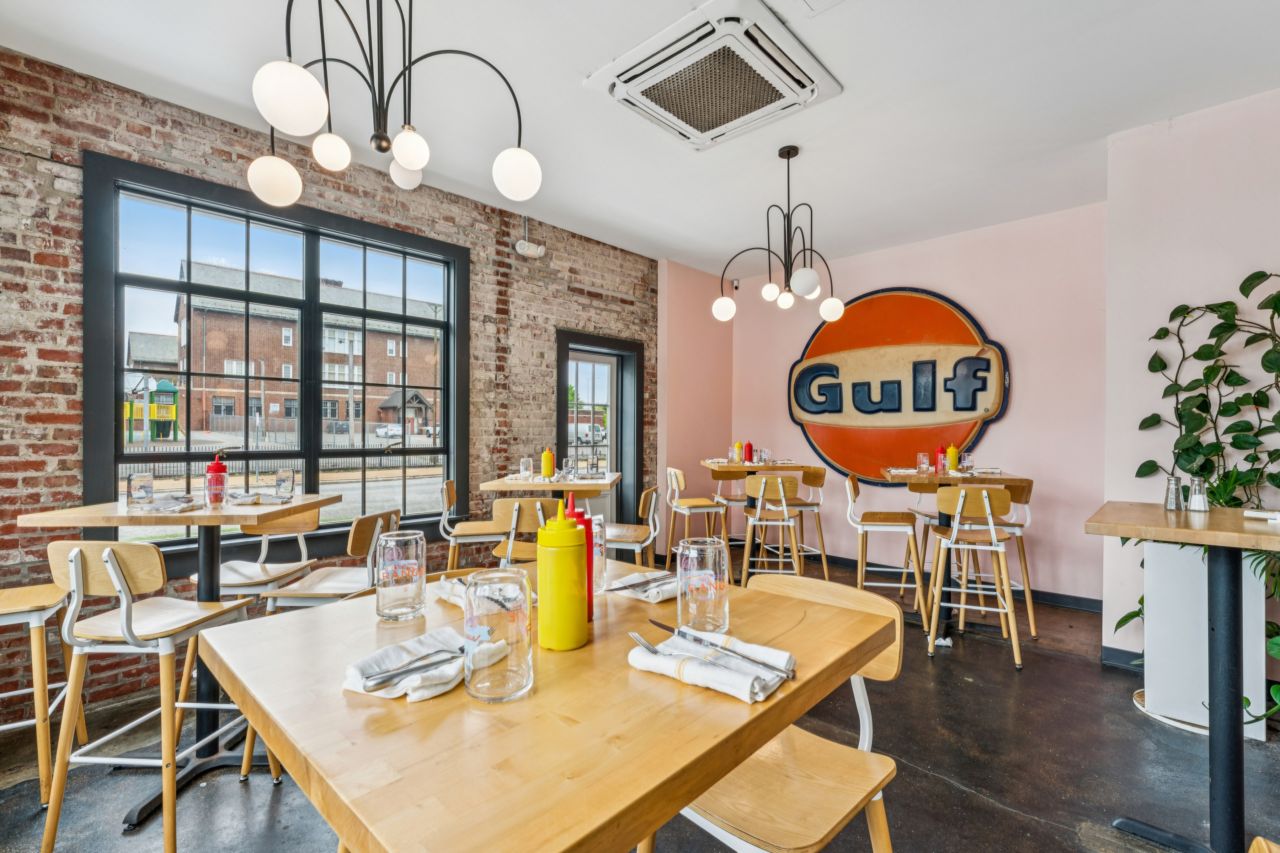 Dining area with brick walls and large windows at restaurant at historic commercial property at 4175 Shaw Blvd in St. Louis Missouri