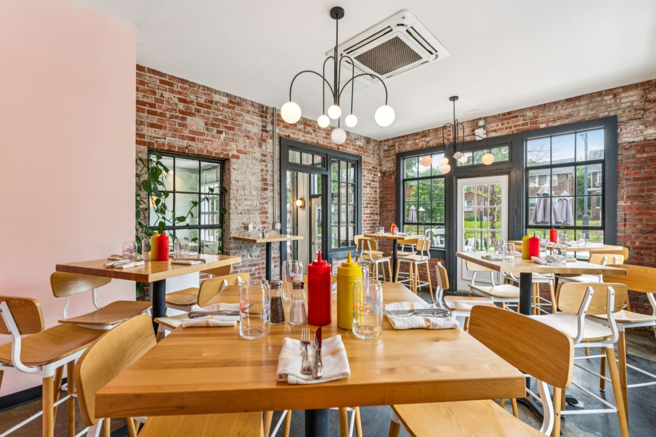 Dining area with brick walls and large windows at restaurant at historic commercial property at 4175 Shaw Blvd in St. Louis Missouri