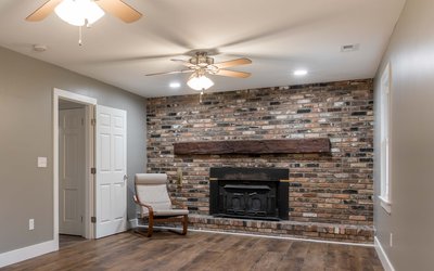 Rustic fireplace with brick surround and wood mantle