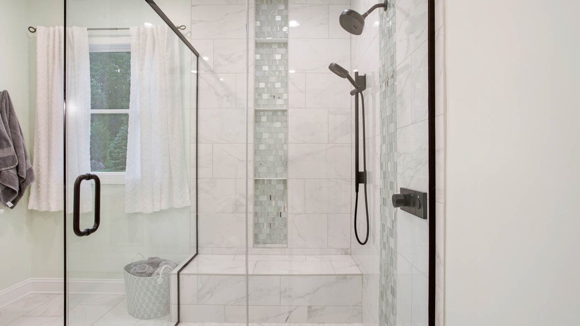 Seafoam tiled shower with custom niche and bench