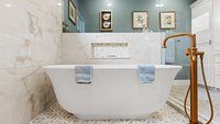 Blue primary bathroom remodel with freestanding tub in shower